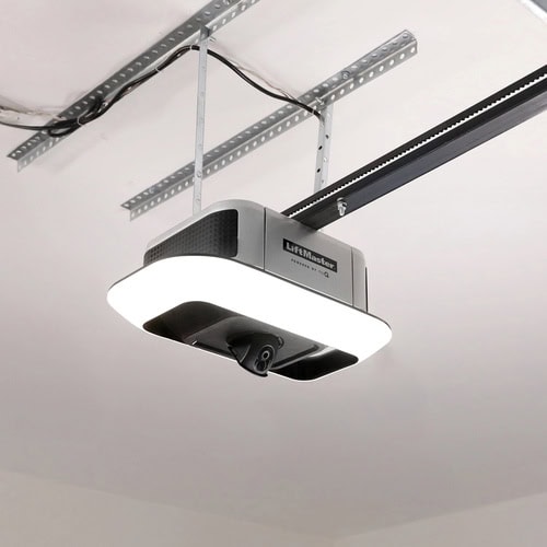Ceiling-mounted LiftMaster garage door opener with a lighted base, attached to a metal track, installed on the ceiling.