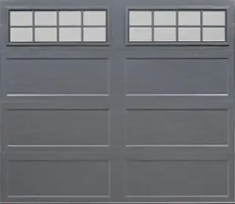 Gray garage door with two rows of rectangular panels and two small windows, each divided into six panes, at the top.