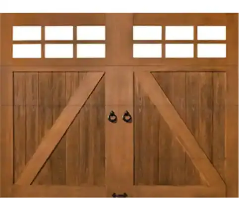 A wooden double garage door with rectangular glass panes at the top and black metal handles in the center.